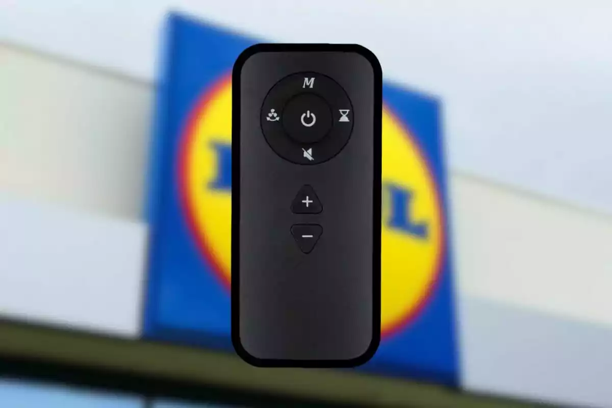Control remoto negro con varios botones en primer plano y el logo de una tienda Lidl desenfocado al fondo Control remoto negro con varios botones en primer plano y el logo de una tienda Lidl desenfocado al fondo