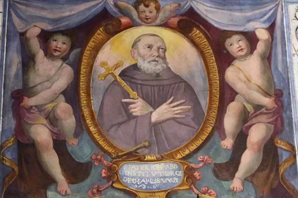 Pintura religiosa de un fraile con barba y hábito sosteniendo una cruz dorada rodeado de querubines y un marco ovalado decorativo
