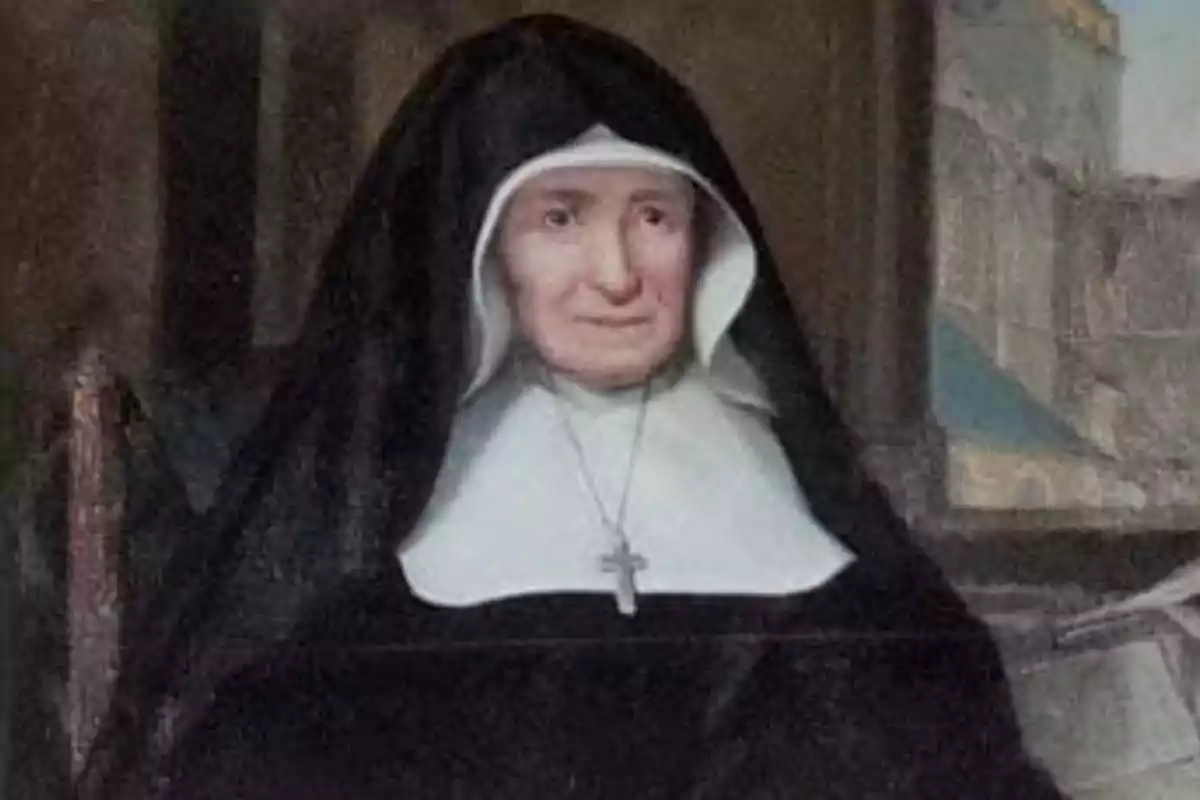 Mujer mayor vestida con hábito religioso negro y blanco, sentada y usando un crucifijo en el cuello Mujer mayor vestida con hábito religioso negro y blanco, sentada y usando un crucifijo en el cuello