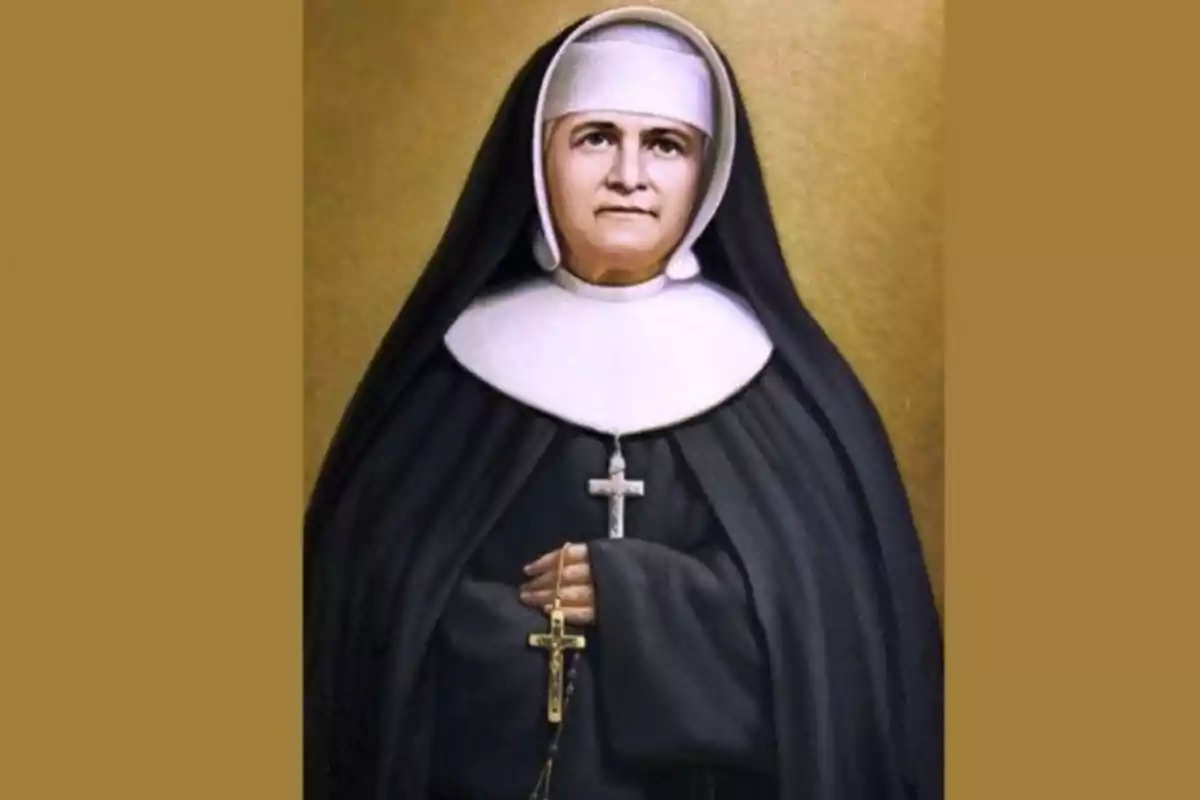 Una monja con hábito negro y blanco sosteniendo un rosario con un crucifijo. Una monja con hábito negro y blanco sosteniendo un rosario con un crucifijo.