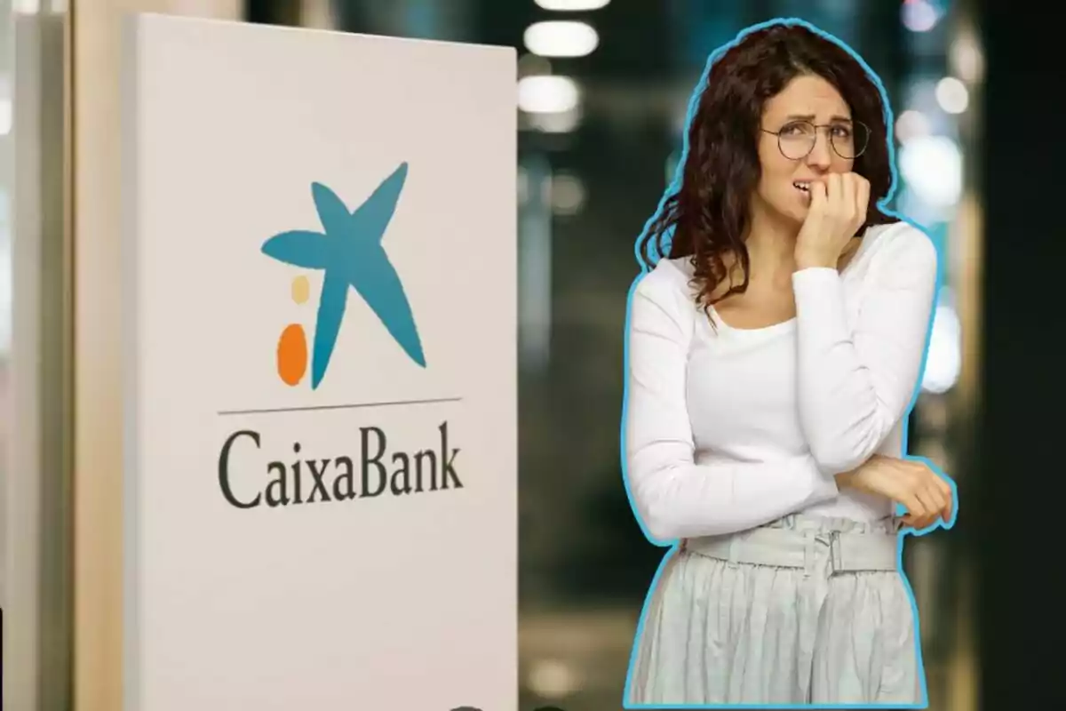 Una mujer con expresión de preocupación está de pie junto a un cartel de CaixaBank.