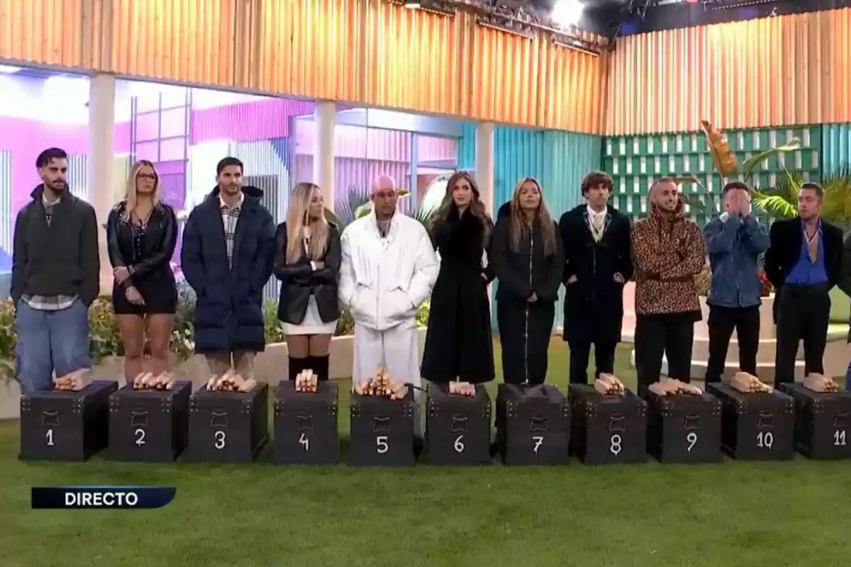 Todos los concursantes de Gran Hermano en el jardín delante de cajas numeradas con unas estacas encima en el juego de Big Bro.