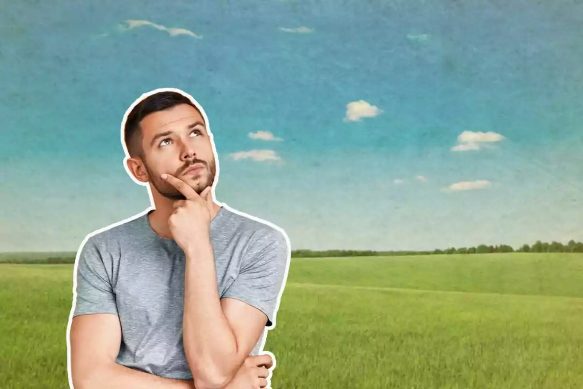 Hombre pensativo en un campo verde bajo un cielo azul con nubes. Hombre pensativo en un campo verde bajo un cielo azul con nubes.