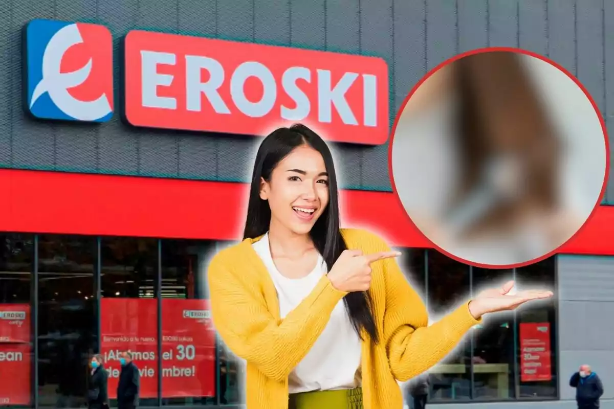 Mujer sonriendo y señalando con el dedo frente a una tienda Eroski.