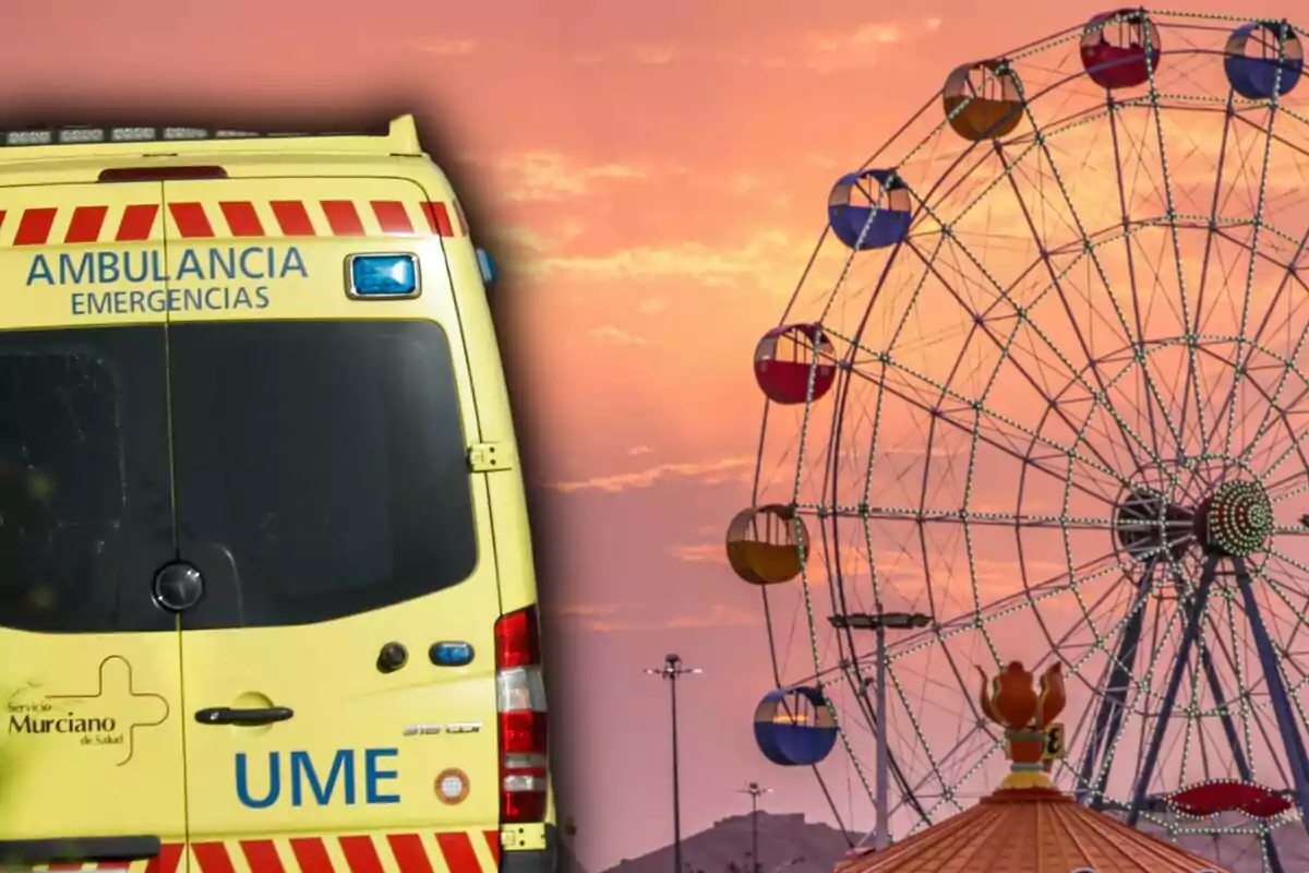 Ambulancia de emergencias estacionada junto a una noria en una feria al atardecer