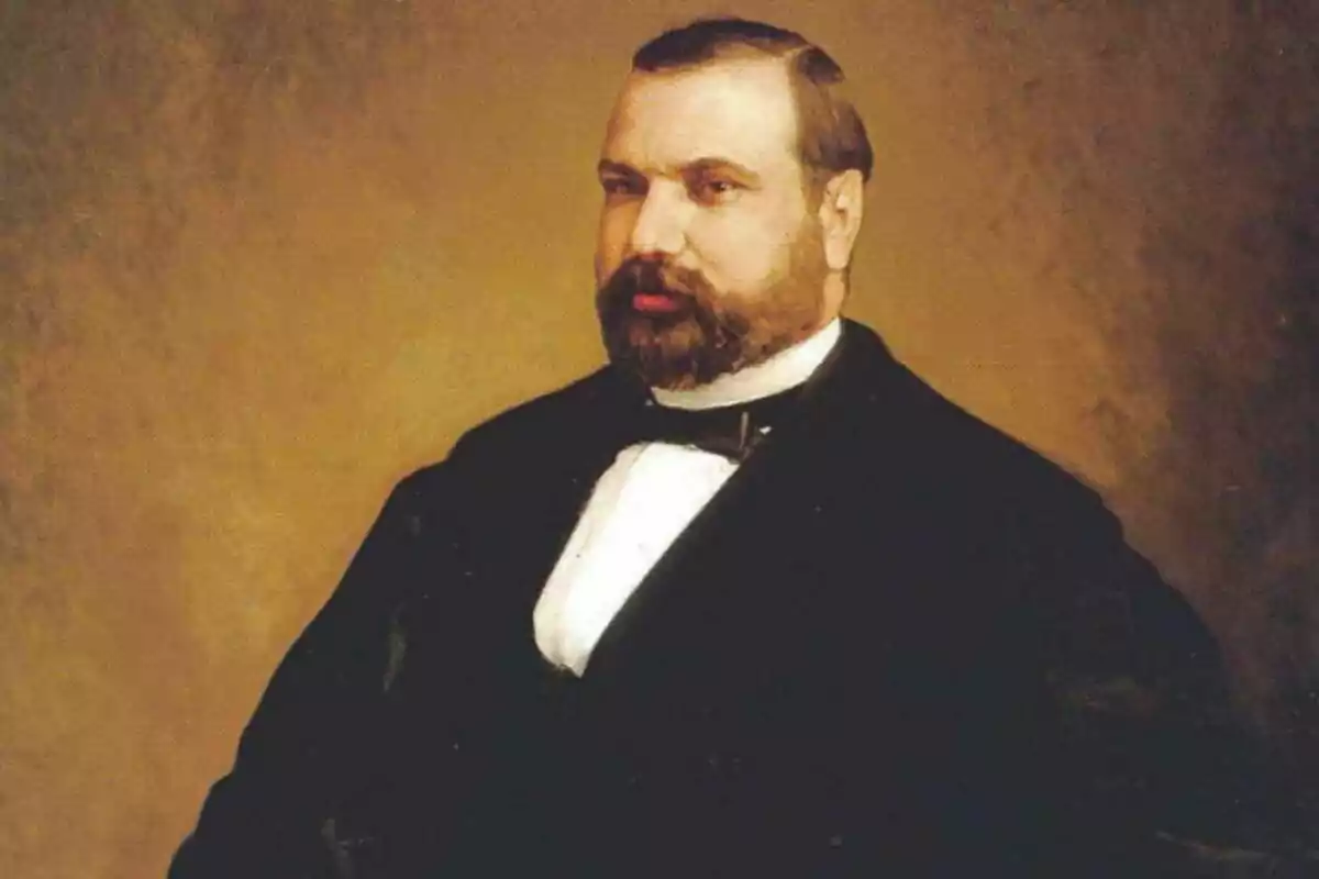 Retrato de Nicolás María Rivero con barba y bigote vestido con un traje formal oscuro y corbata de lazo sobre un fondo marrón. Retrato de Nicolás María Rivero con barba y bigote vestido con un traje formal oscuro y corbata de lazo sobre un fondo marrón.