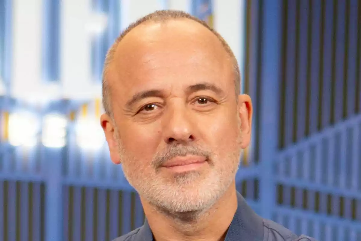 Primer plano de Javier Gutiérrez con expresión nuetral y fondo azul en el rodaje de La Agencia.