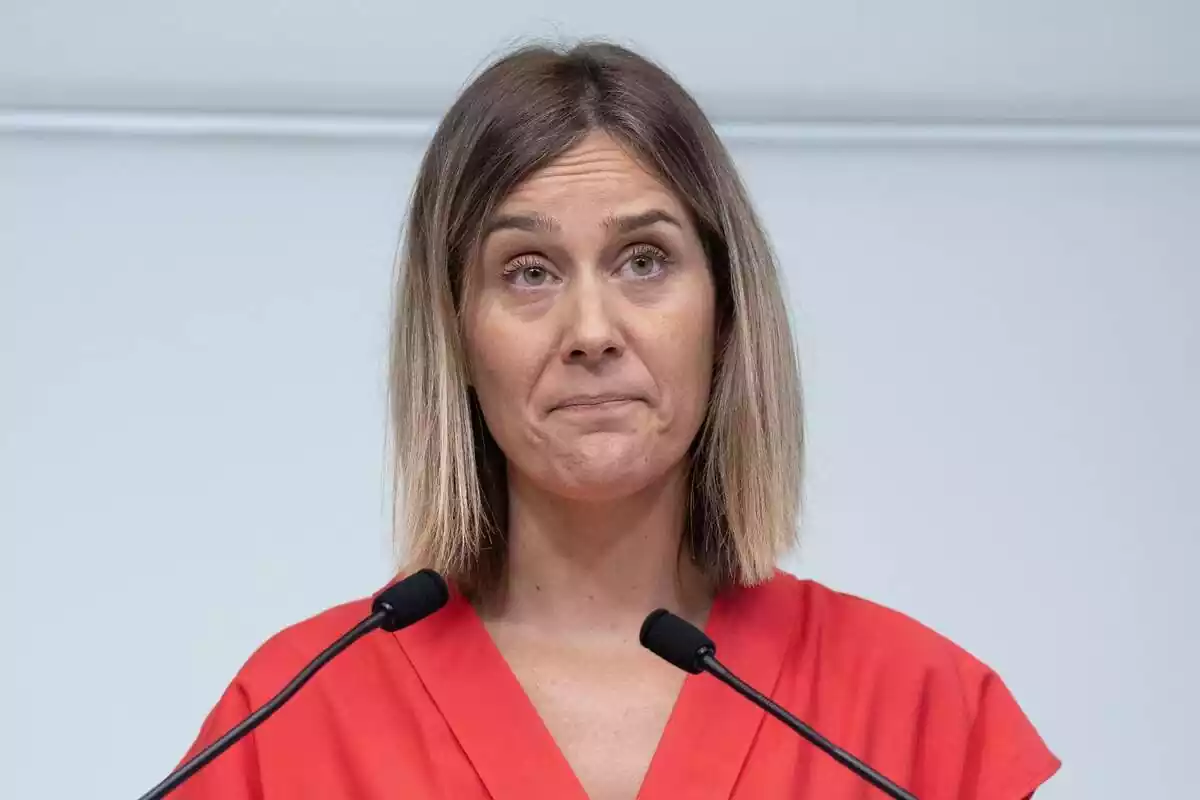 Primer plano de la líder de los comunes en Cataluña, Jéssica Albiach, con un vestido rojo y cara de incredulidad