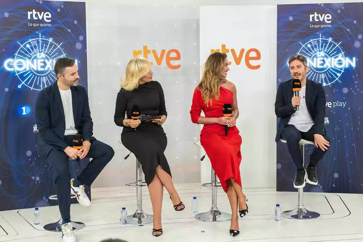 David Gallart, María Eizaguirre, Lara Álvarez y Sergio Calderón sentadas en taburetes participan en una charla con micrófonos de rtve en un set moderno con fondo blanco y azul David Gallart, María Eizaguirre, Lara Álvarez y Sergio Calderón sentadas en taburetes participan en una charla con micrófonos de rtve en un set moderno con fondo blanco y azul