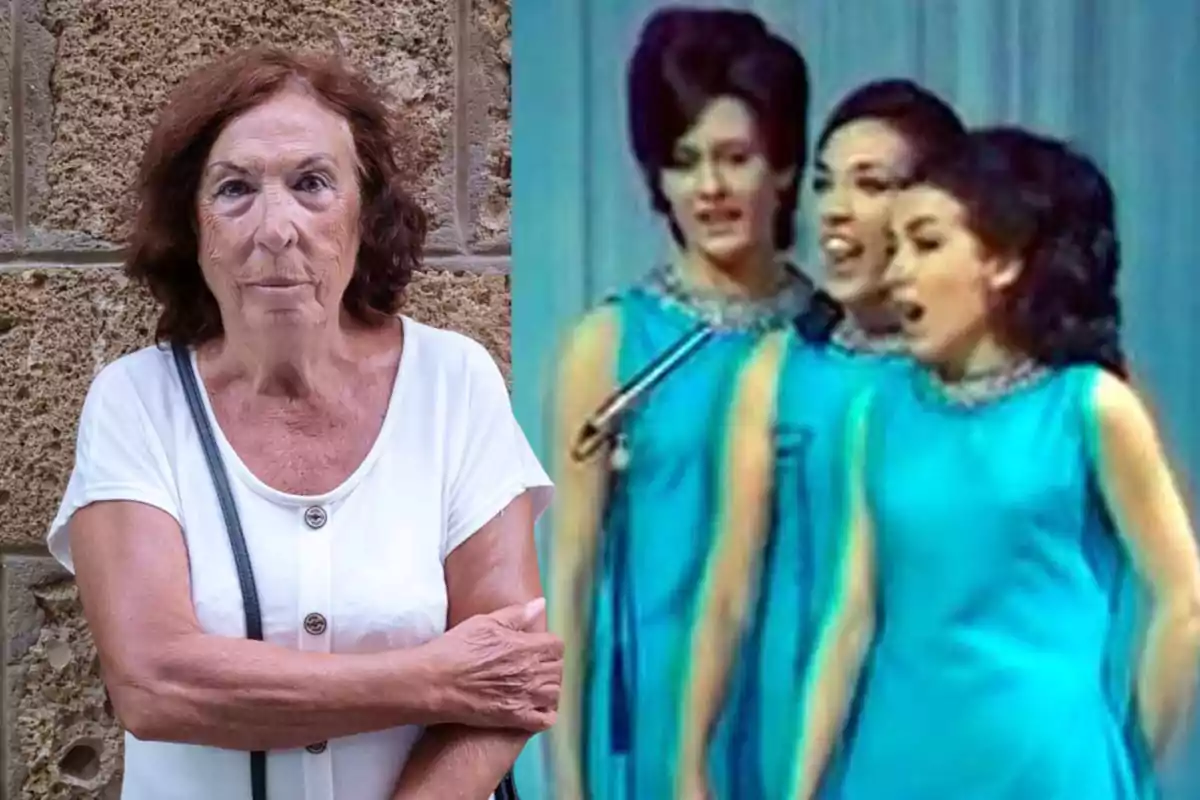 La Macaria, con cabello castaño y una camiseta blanca, está de pie junto a una imagen de tres mujeres jóvenes cantando en un escenario, vestidas con vestidos azules. La Macaria, con cabello castaño y una camiseta blanca, está de pie junto a una imagen de tres mujeres jóvenes cantando en un escenario, vestidas con vestidos azules.