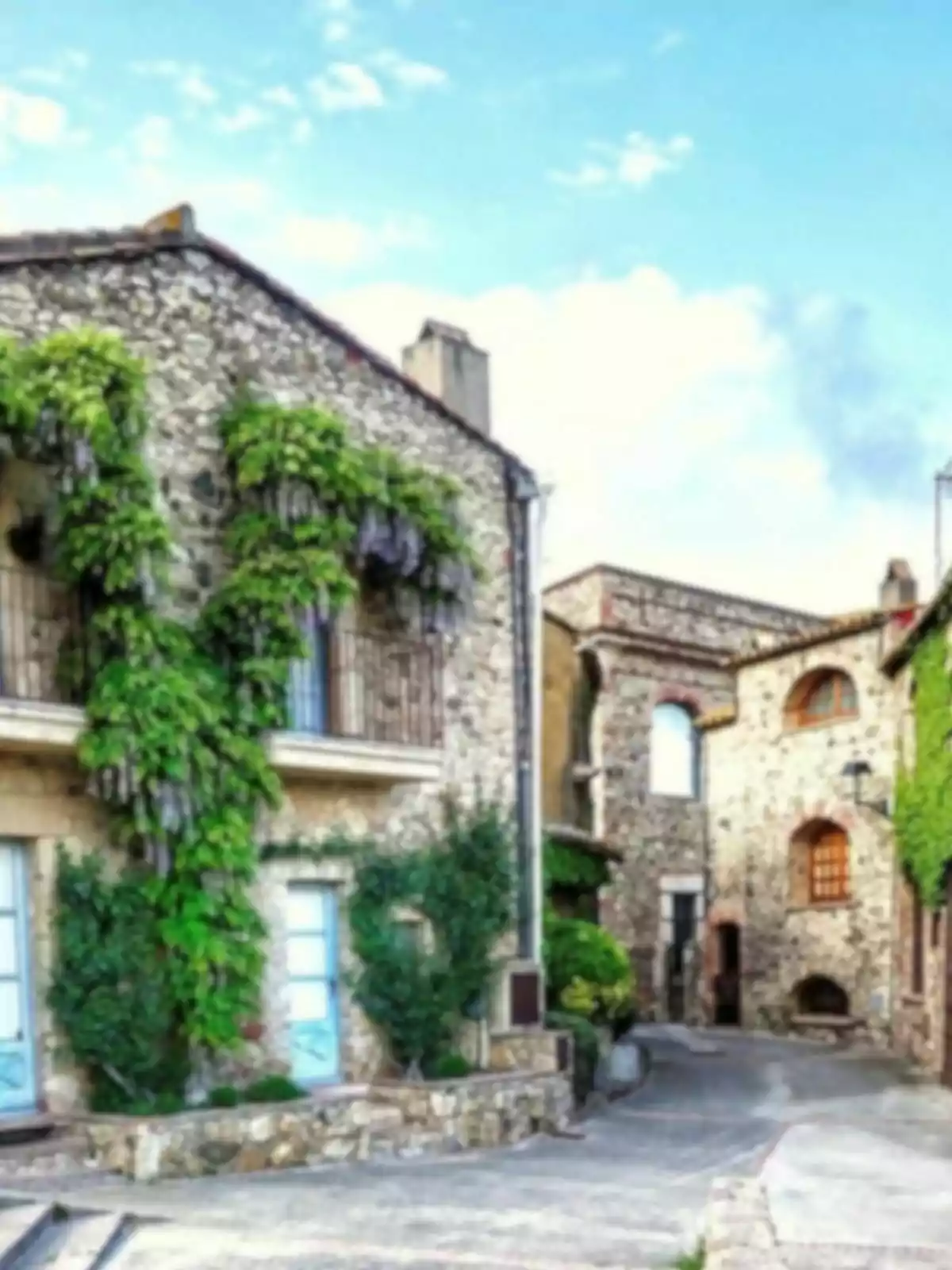 Una calle estrecha con casas de piedra cubiertas de enredaderas verdes bajo un cielo azul. Una calle estrecha con casas de piedra cubiertas de enredaderas verdes bajo un cielo azul.