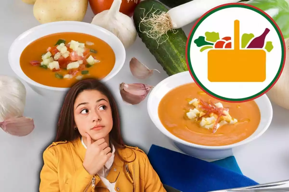 Una mujer pensativa con una chaqueta amarilla está frente a dos platos de sopa de tomate con verduras, rodeada de ingredientes frescos como ajo, pepino, patatas y tomates, junto a un logotipo de una cesta de alimentos.