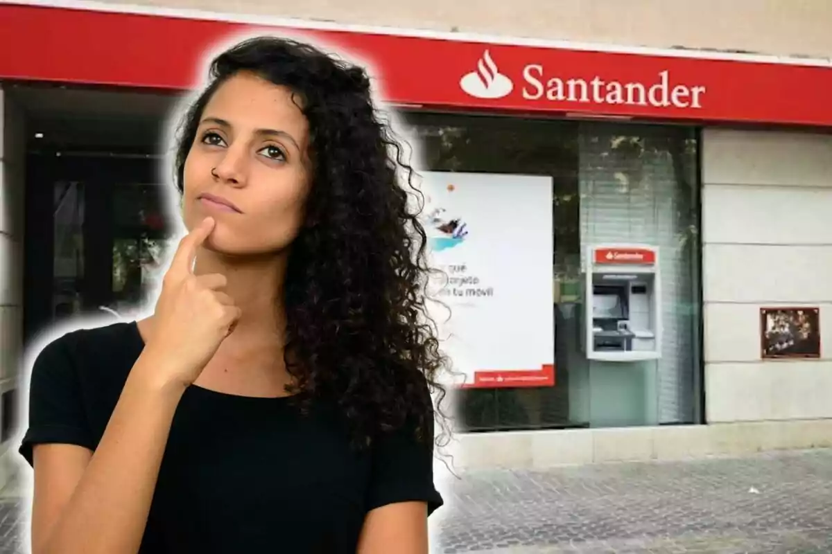 Mujer pensativa frente a una sucursal del banco Santander.