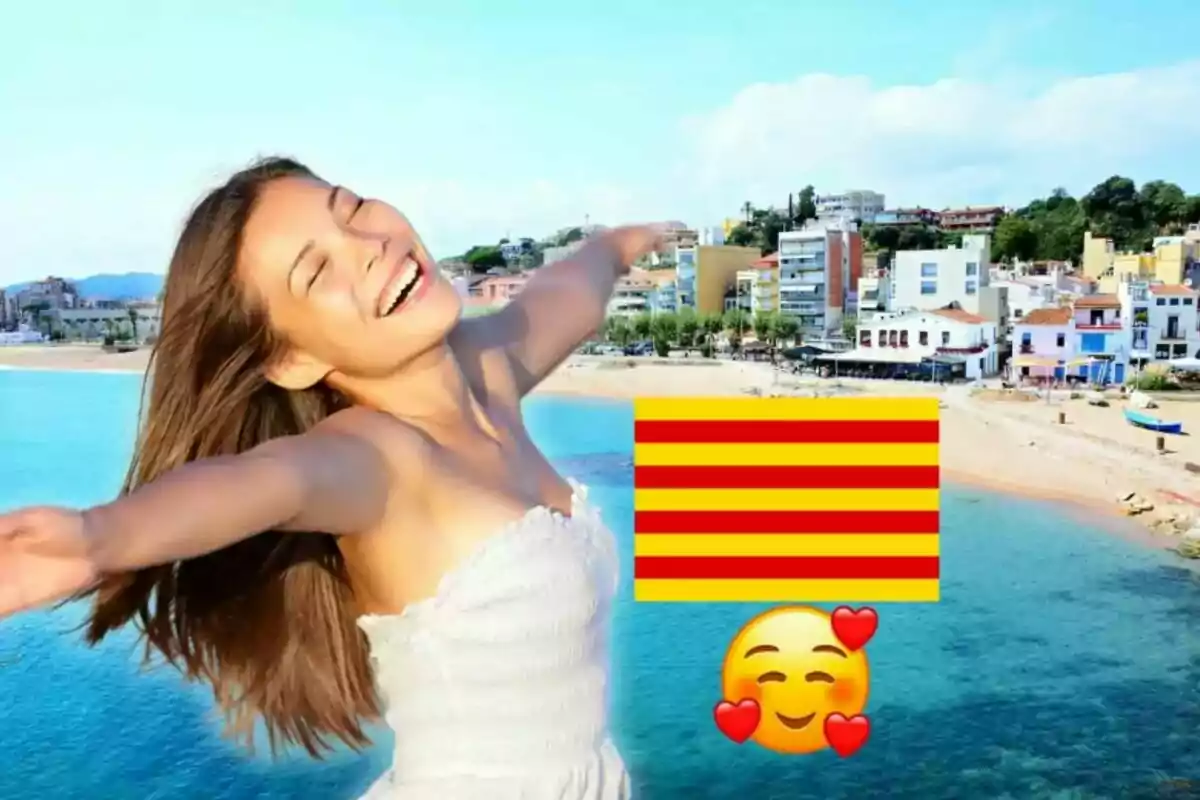 Una mujer sonriente con los brazos extendidos frente a una playa y edificios, junto a una bandera catalana y un emoji sonriente con corazones.