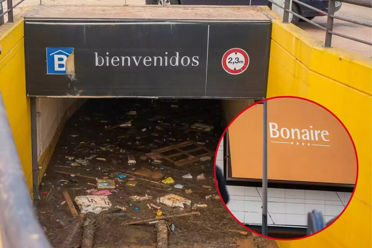 Entrada de un estacionamiento subterráneo inundado con escombros y un cartel que indica una altura máxima de 2,3 metros; en un recuadro se muestra un letrero del centro comercial Bonaire.