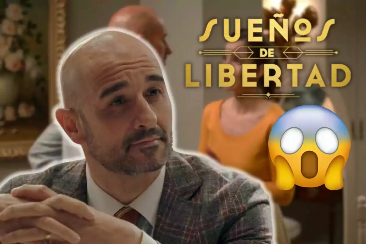 Alain Hernández con barba y traje a cuadros aparece en primer plano con una expresión pensativa mientras al fondo se ve el título "Sueños de Libertad" y un emoji sorprendido.