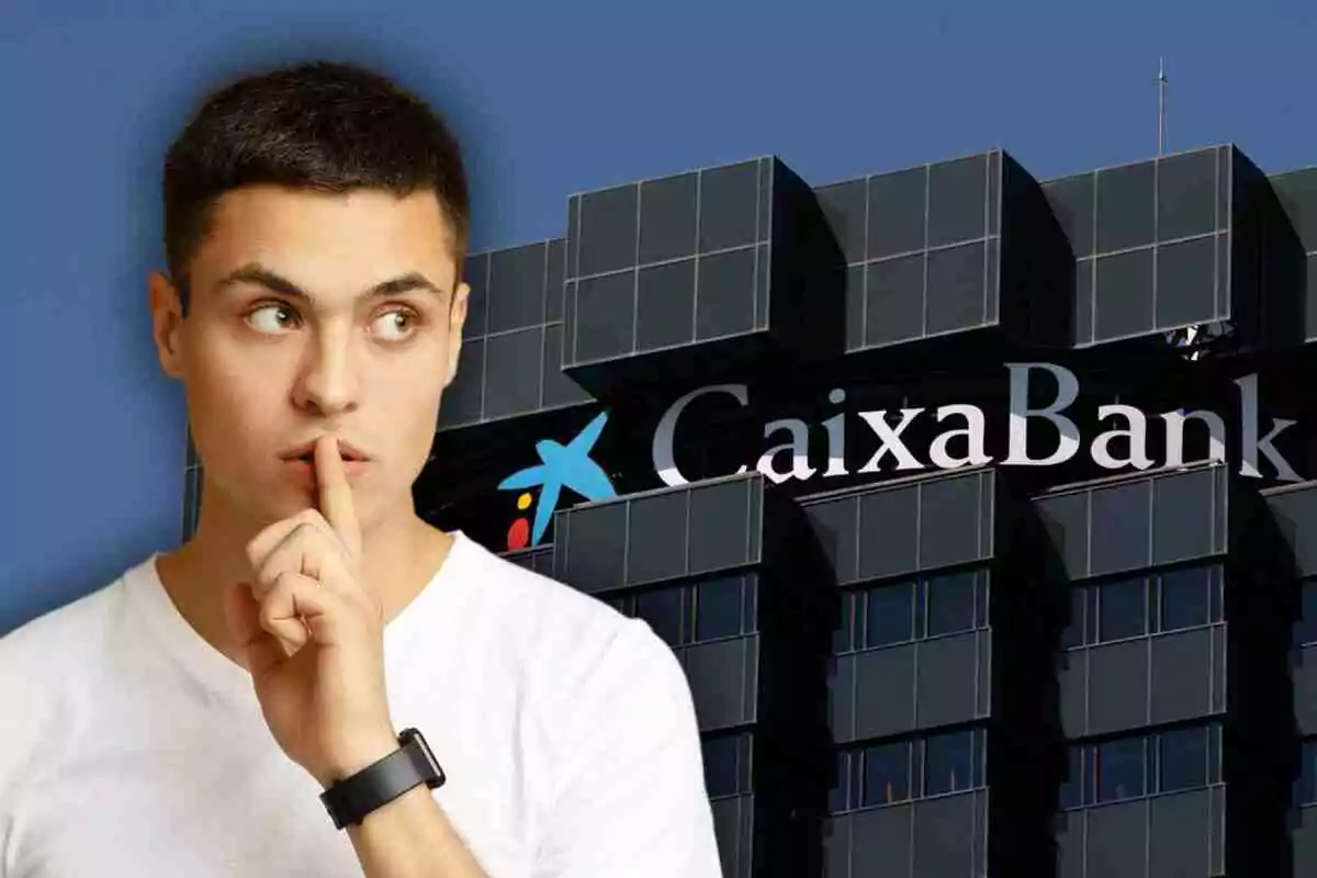 Un hombre con gesto de silencio frente a un edificio de CaixaBank. Un hombre con gesto de silencio frente a un edificio de CaixaBank.