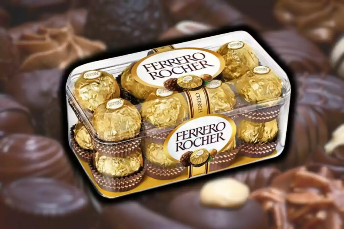 Caja de bombones Ferrero Rocher con envoltura dorada sobre un fondo de chocolates variados. Caja de bombones Ferrero Rocher con envoltura dorada sobre un fondo de chocolates variados.