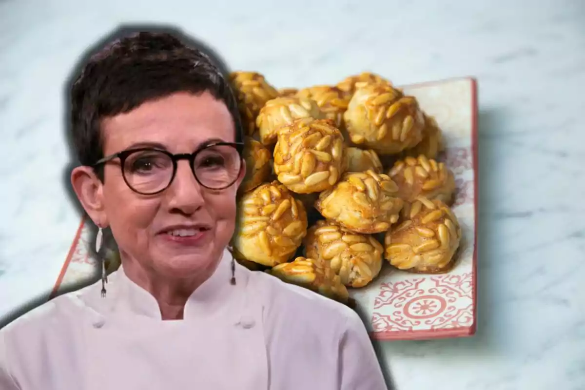 Carme Ruscalleda con gafas y chaqueta de chef frente a un plato de panellets.