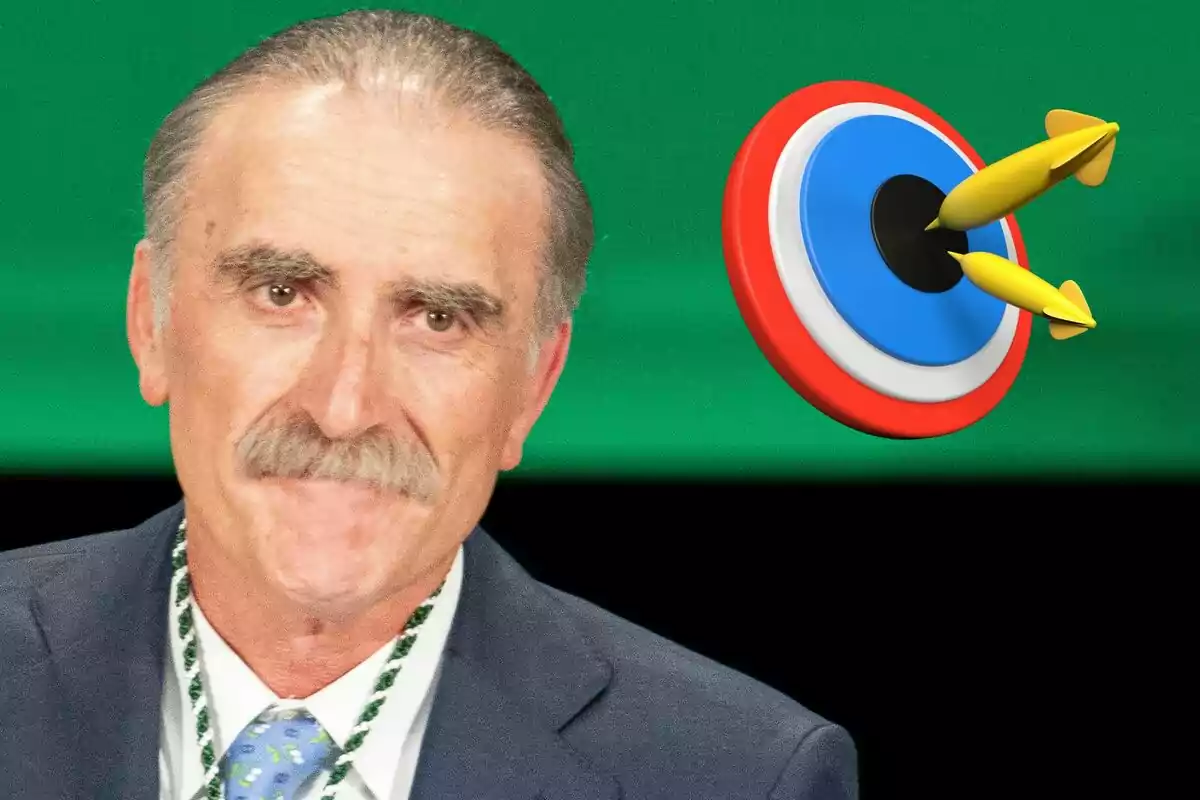 Juan y Medio con bigote y traje frente a un fondo verde con un objetivo de dardos.