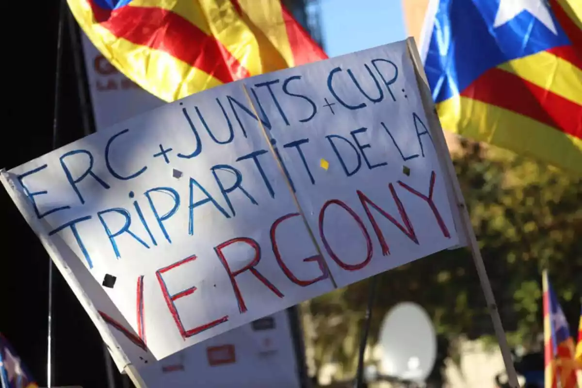 Imagen de una pancarta con el texto ERC + Junts + Cup tripartito de la verguenza