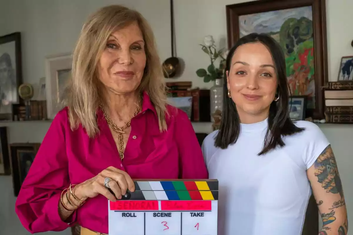 Pilar Eyre y Sindy Takanashi posan juntas en una habitación, una de ellas sostiene una claqueta de cine de ¡Señora!.