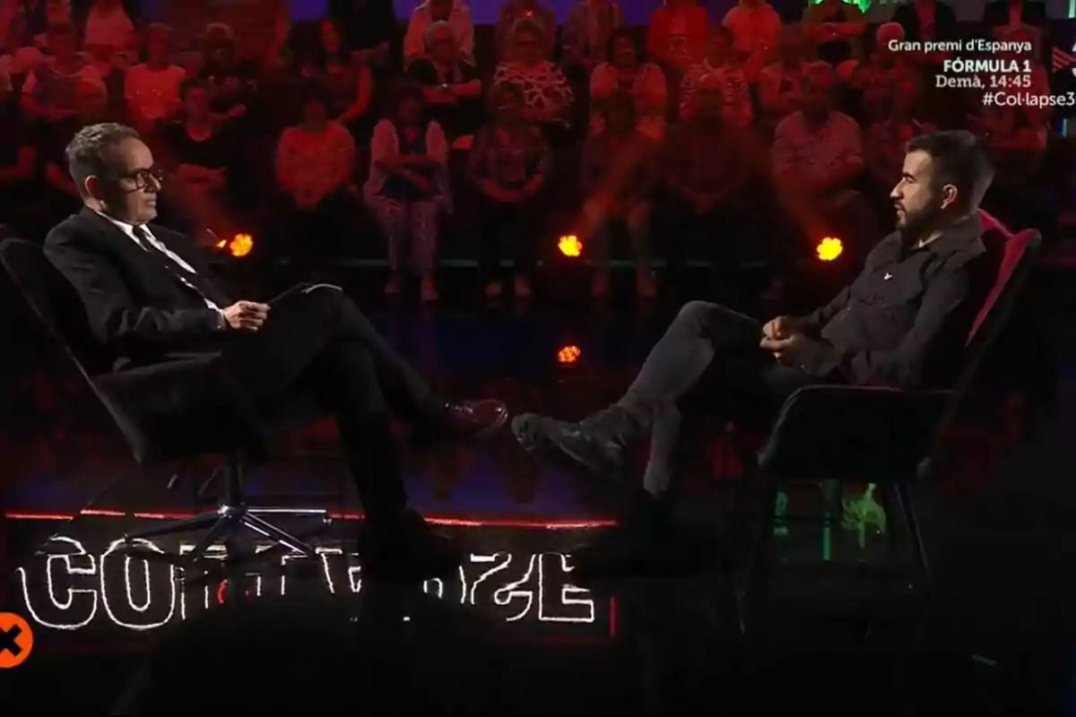 Ricard Ustrell y Àngel Llàcer sentados uno frente al otro en un set de televisión de Col·lapse con público al fondo y luces tenues en TV3 Ricard Ustrell y Àngel Llàcer sentados uno frente al otro en un set de televisión de Col·lapse con público al fondo y luces tenues en TV3