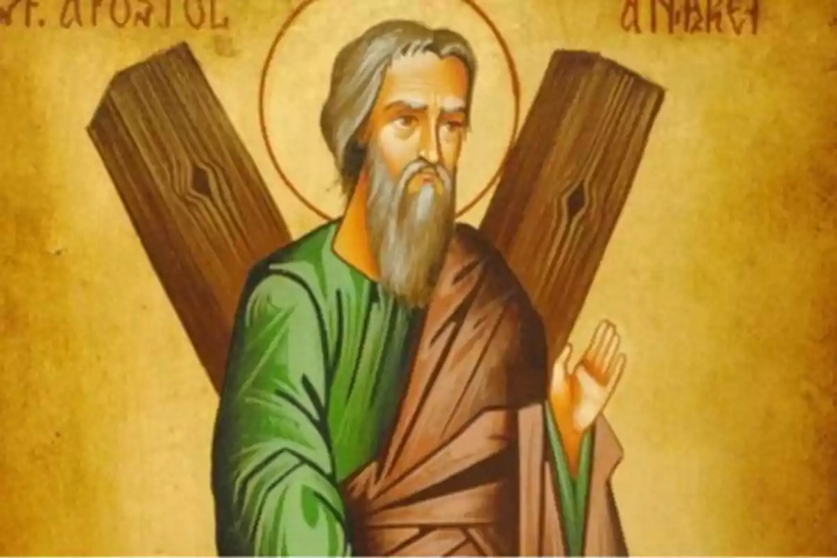 Imagen de un icono religioso que representa a un hombre con barba y cabello canoso, vestido con túnica verde y manto marrón, sosteniendo una cruz en forma de X.