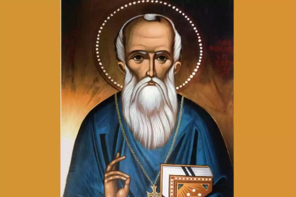 Icono religioso de un santo con aureola, barba blanca y túnica azul, sosteniendo un libro y haciendo un gesto de bendición. Icono religioso de un santo con aureola, barba blanca y túnica azul, sosteniendo un libro y haciendo un gesto de bendición.