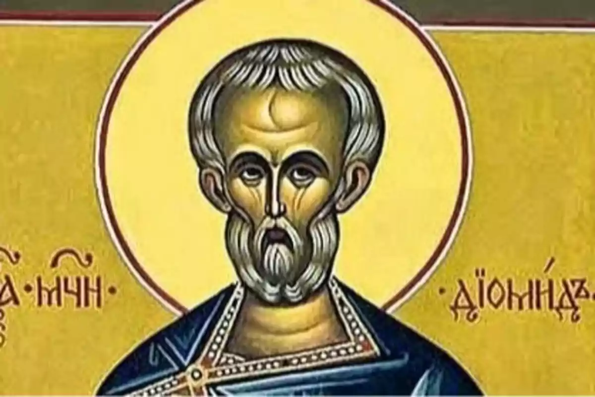 Icono religioso de un hombre con barba y halo dorado sobre fondo amarillo con letras en griego a los lados Icono religioso de un hombre con barba y halo dorado sobre fondo amarillo con letras en griego a los lados