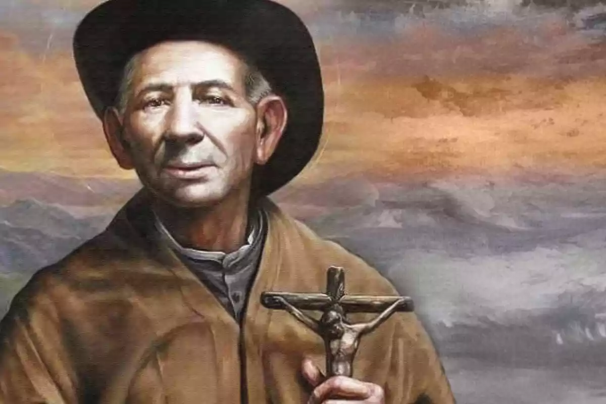 Un hombre con sombrero sostiene un crucifijo en un paisaje pintado. Un hombre con sombrero sostiene un crucifijo en un paisaje pintado.