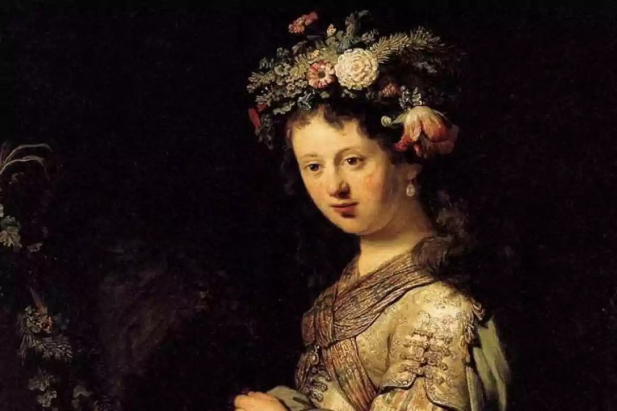 Retrato de una mujer con corona de flores en un fondo oscuro.