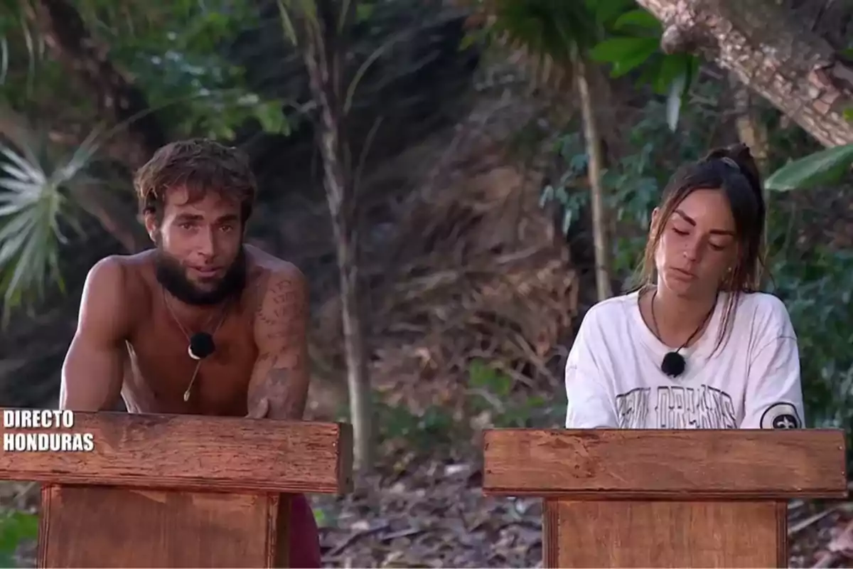 Montoya y Anita están de pie detrás de atriles de madera en un entorno al aire libre con vegetación de fondo. Captura de 'Supervivientes' Montoya y Anita están de pie detrás de atriles de madera en un entorno al aire libre con vegetación de fondo. Captura de 'Supervivientes'