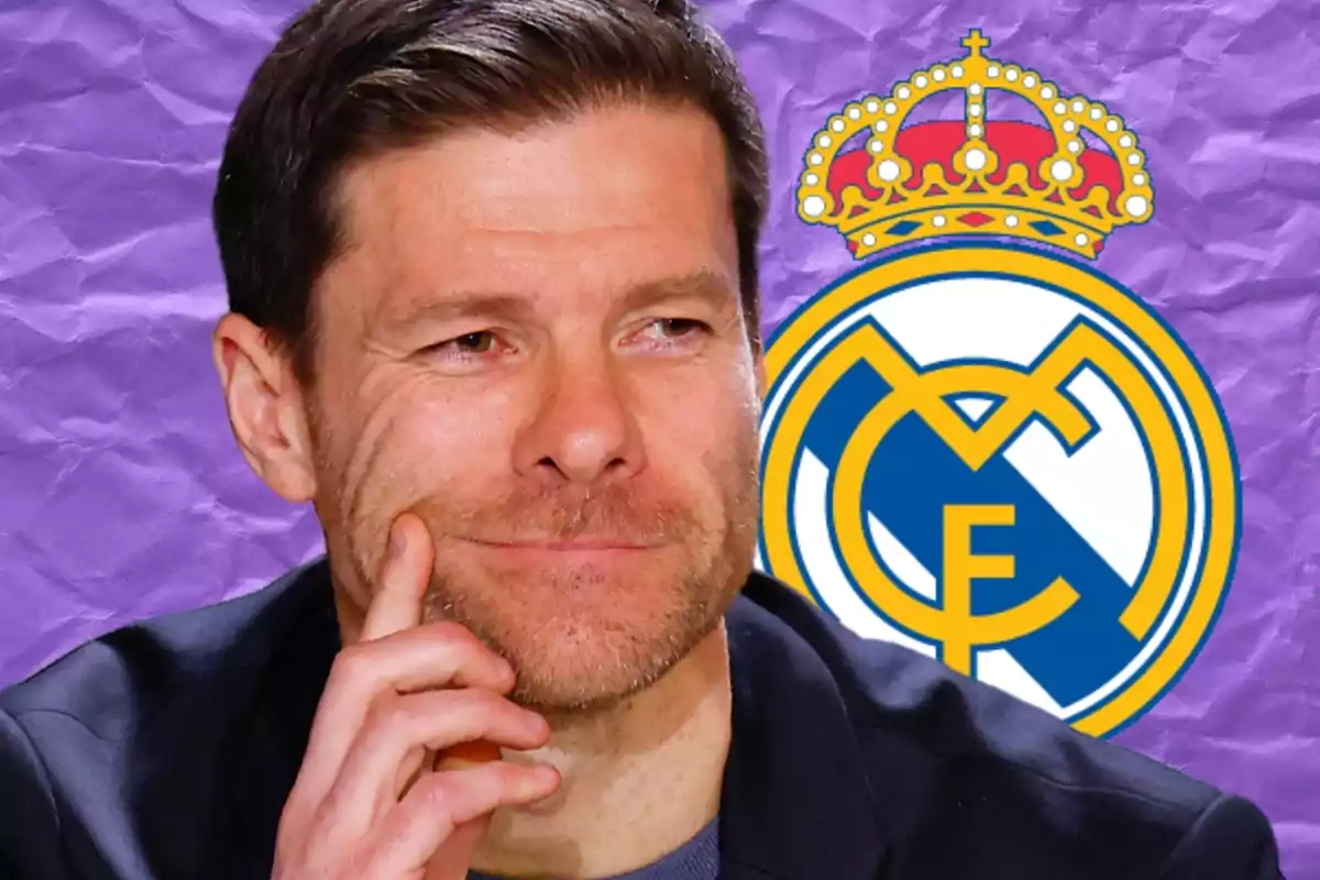 Un hombre pensativo con barba ligera frente a un fondo morado con el escudo del Real Madrid.